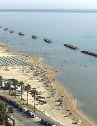 High angle view of crowded beach  against sky