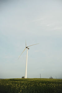 Windmill on field against sky