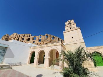 Low angle view of historic building against clear blue sky