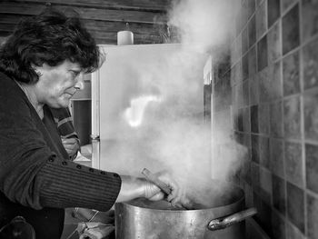 Side view of man working in kitchen