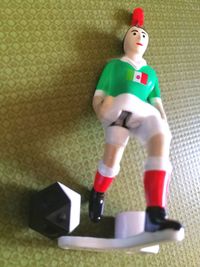 Close-up of figurine with toy on table