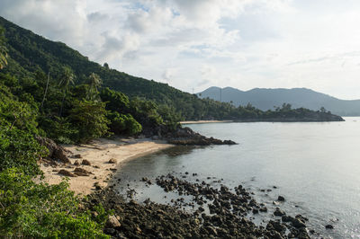 Scenic view of sea and mountains against sky