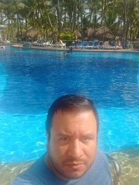 Portrait of man swimming in pool