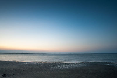 Scenic view of sea against clear sky at sunset