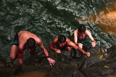 High angle view of men swimming in lake