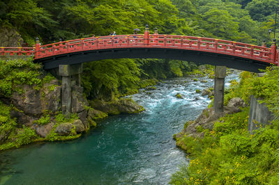 Famous red arch bridge over river in forest at nikko, japan