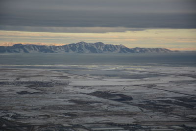 Scenic view of snowcapped mountains against sky during sunset