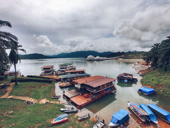 High angle view of boats moored at harbor against sky