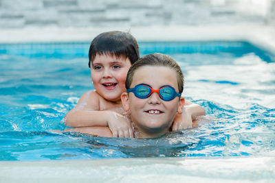 Portrait of smiling boy in swimming pool