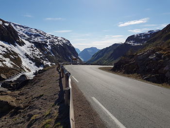 Road amidst mountains against sky