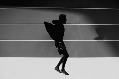 Man jumping against wall