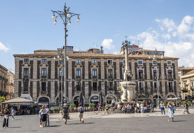 Group of people in front of historic building