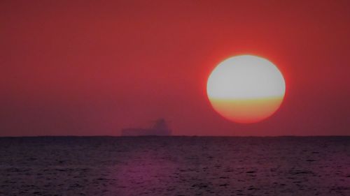 Scenic view of sea against clear sky during sunset