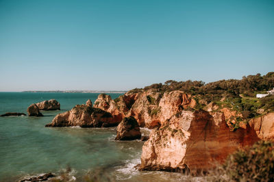 Scenic view of sea against clear blue sky