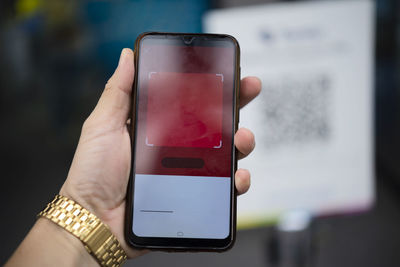 Close-up of hand holding smart phone