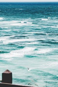 Seagull flying over sea against sky