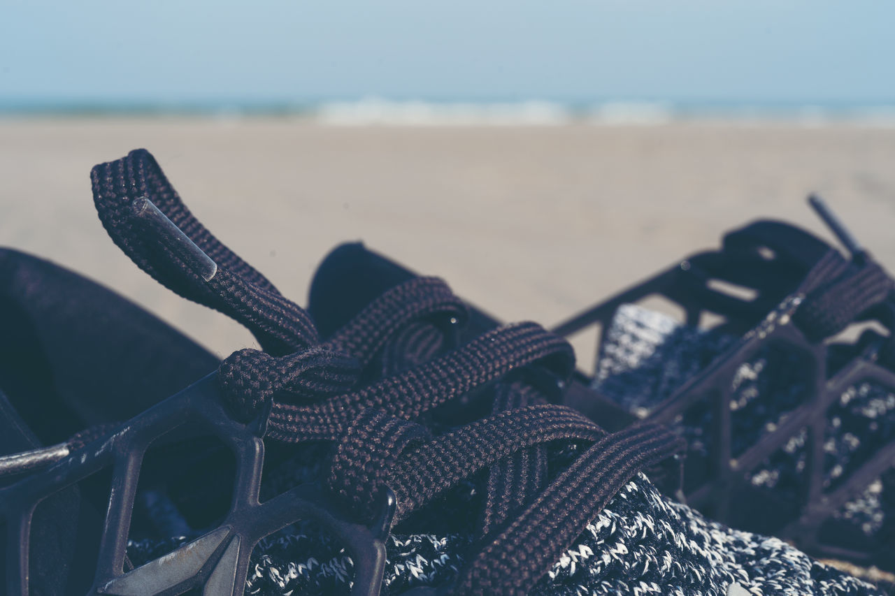 CLOSE-UP OF BICYCLE BY PIER AT BEACH