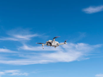 Low angle view of airplane flying against sky