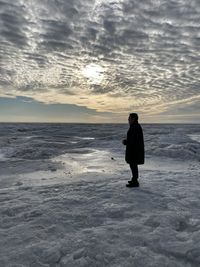 Full length of man standing on beach during sunset