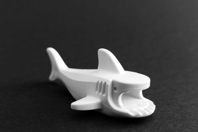 Close-up of white toy against black background