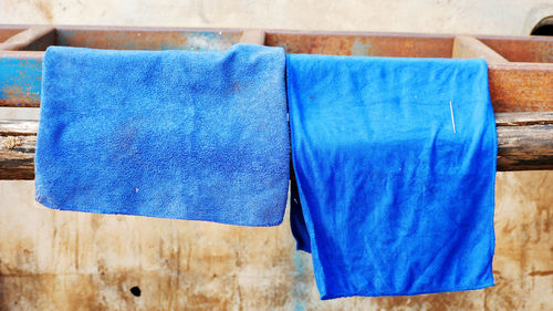 Close-up of towels drying on metal