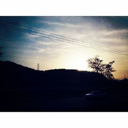 Silhouette of trees against sky at sunset