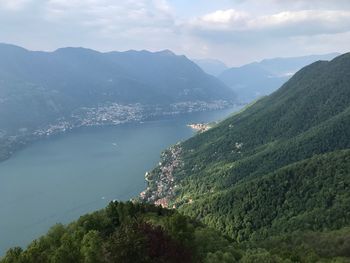 High angle view of lake and mountains against sky