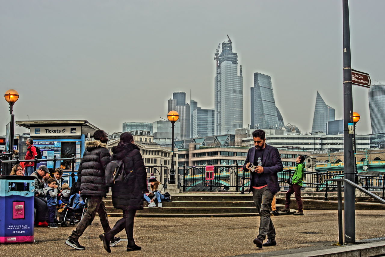 FULL LENGTH OF PEOPLE STANDING AGAINST BUILDINGS