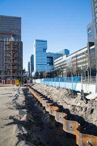 Buildings in city against clear blue sky