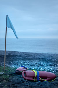 Low section of person on beach against sky