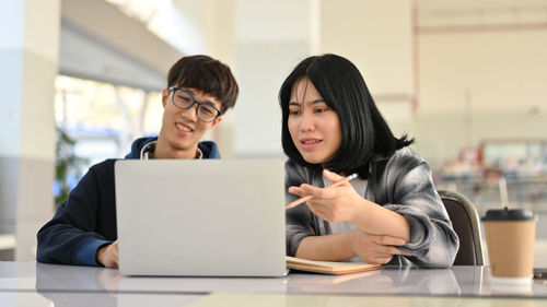 Young woman using laptop at office