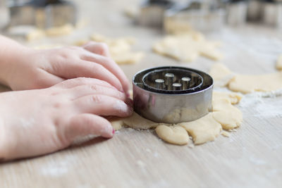 Close-up of girl's hand on table
