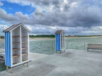 Lifeguard hut on beach against sky