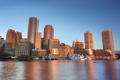 River by buildings against sky against blue sky