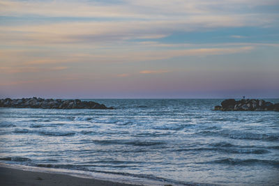 Scenic view of sea against sky at sunset