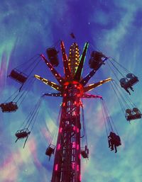 Low angle view of chain swing ride against sky