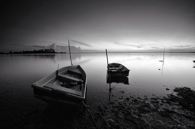 Boat moored on sea against sky