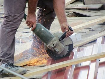 Low section of man working on wood