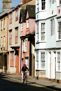 Rear view of woman walking on street in city