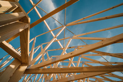 Low angle view of metallic structure against sky