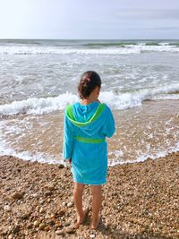 Real view of girl standing on beach