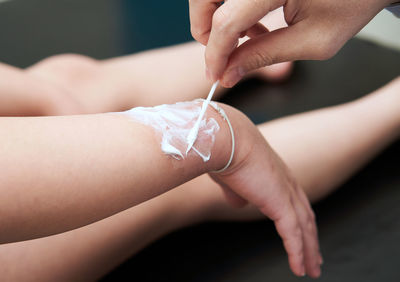 Cropped image of woman holding dentures