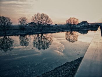 Scenic view of lake against sky at sunset