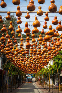 Pedestrian tourist street decorated with a suspension with various clay pots 