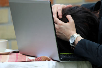 Midsection of woman working on table