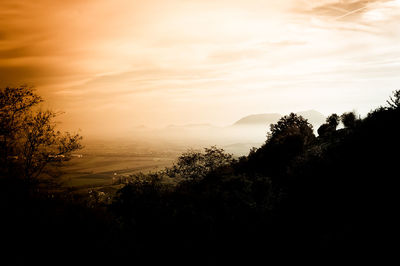 Scenic view of landscape against sky at sunset