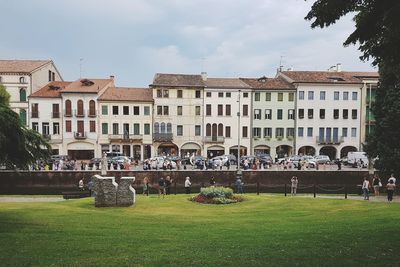 People against buildings in city