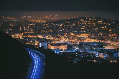 High angle view of illuminated city buildings at night