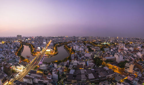 High angle view of illuminated city buildings against sky