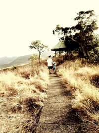 Rear view of men walking in park